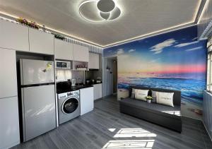 a kitchen with a washing machine in a room at 3BR Romantic apt, 2mins MTR, 8pax in Hong Kong