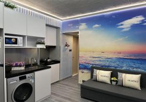 a kitchen with a painting of the ocean at 3BR Romantic apt, 2mins MTR, 8pax in Hong Kong