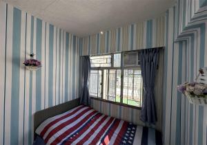 a bedroom with a bed with an american flag blanket at 3BR Romantic apt, 2mins MTR, 8pax in Hong Kong