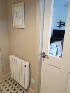 a room with a door with a radiator and a mirror at Big Blue in Clonakilty