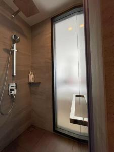 a bathroom with a shower with a glass door at EDGE Central Pattaya in Pattaya Central