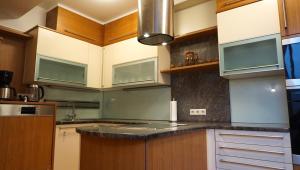 a kitchen with wooden cabinets and a black counter top at Biohof Kroisleitner in Sankt Jakob im Walde