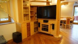 a living room with a flat screen tv on a stand at Biohof Kroisleitner in Sankt Jakob im Walde
