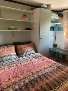 a bedroom with a bed in a room with shelves at Welcome, relax and enjoy your stay in Putten