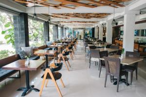 a row of tables and chairs in a restaurant at S18 Bali Villas in Legian