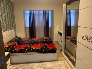 a small bedroom with a bed and a mirror at Dream Home in Baku