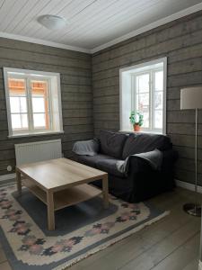 a living room with a couch and a coffee table at Helsingegården in Järvsö