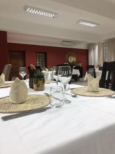 una mesa con copas de vino y servilletas. en Inhambane Hotel Escola, en Inhambane