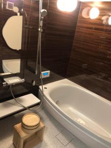 a bathroom with a toilet and a bath tub at 島宿糸 in Iki