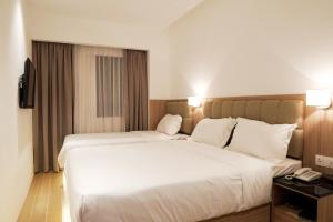 Postel nebo postele na pokoji v ubytování D Loft Hotel