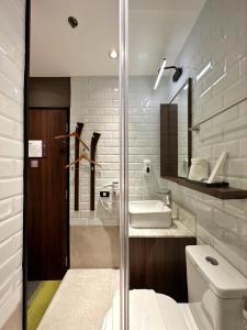 a bathroom with a toilet and a sink at Aerotel Cebu in Mactan
