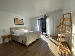 a bedroom with a bed and a ladder in it at ANA Apartments Sinaia in Sinaia