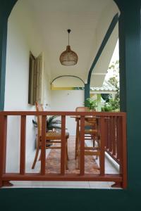 a balcony with a wooden table and chairs at Tara Resort in Nathon