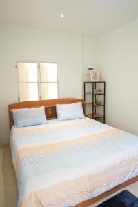 a bedroom with a large bed with a wooden headboard at Tara Resort in Nathon