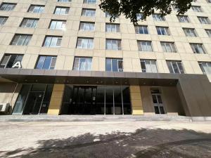 a large building with a lot of windows at Tianjin Crown International Apartment in Tianjin