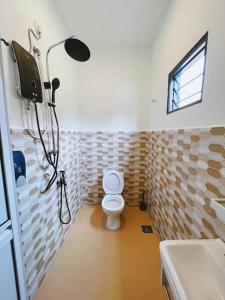 a bathroom with a shower with a toilet and a sink at Villa D'Razna - Luxury 5-bedroom Villa with private pool in Kuala Terengganu
