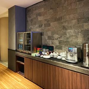 a kitchen with a counter with a coffee maker at Aerotel Cebu in Mactan