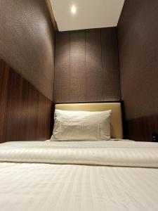 a bedroom with a bed with a brown headboard at Aerotel Cebu in Mactan