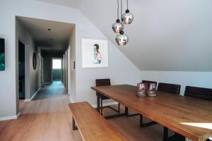 a dining room with a wooden table and chairs at Trolltunga Panorama in Tysso