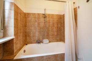 a bathroom with a bath tub with a shower curtain at Residence Hubertus Ap 1 - Meran in Merano