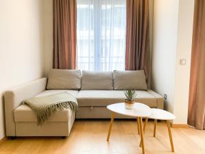 a living room with a couch and a table at Sunny apartment in Bečići