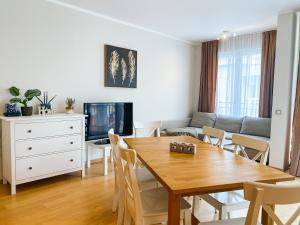 a living room with a wooden table and a couch at Sunny apartment in Bečići