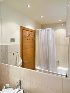 a bathroom with a mirror and a sink and a shower at Sunny apartment in Bečići