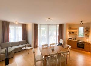 a living room with a table and a couch at Sunny apartment in Bečići