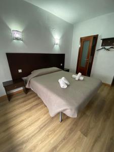En eller flere senge i et værelse på Caçula, Alojamento Local