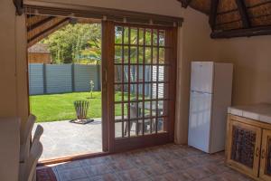 a kitchen with a door open to a yard at Melsetter's Guesthouse in Bloemfontein
