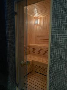 a sauna in a bathroom with a glass door at Omega Hotel in Olsztyn +85 photos