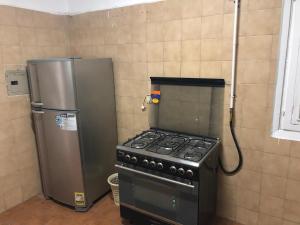 a kitchen with a stove and a refrigerator at Apartment at Milsa Nasr City Building No 8 in Cairo
