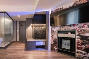 a living room with a fireplace and a tv at Aspira Gems Center Silom in Bangkok