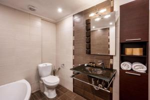 a bathroom with a toilet and a sink at Palmrise Luxury Villas by Travel Pro Services - Nea Skioni Halkidiki in Nea Skioni