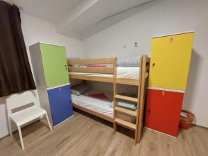 a room with two bunk beds and a chair at Hostel Inn Downtown in Belgrade