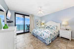 a bedroom with a bed and a balcony at Phoenix X 907 in Orange Beach