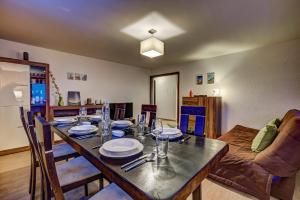 a dining room with a table and a couch at Appartement Rocailles 7 in La Tzoumaz