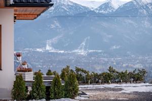 a view of a city with a snow covered mountain at Willa na Grani in Zakopane