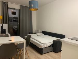 a small bedroom with a bed and a table and chairs at Residence Port Karolina in Prague