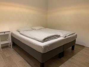 a bed in a bedroom with a white mattress at Residence Port Karolina in Prague