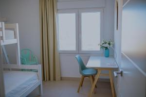 a room with a desk and a chair and a window at Panorama Mar Apartment in Punta Prima +12 photos