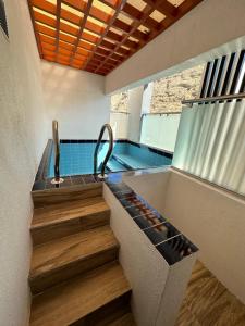 a bathroom with a sink and a swimming pool at Blue Rose Hotel in Al Amarat