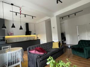 a living room with a couch and a chair at Sobornosti Apartment Poltava City in Poltava
