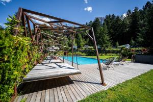 a wooden deck next to a swimming pool at Camping Seiser Alm in Völs am Schlern
