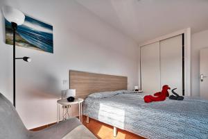a bedroom with a red stuffed animal sitting on a bed at CostaSun and Pool in Costa Calma +31 photos