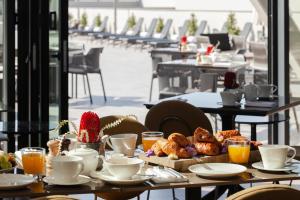 a table with pastries and coffee on top at ONLY Boutique Suites & Residences in Limassol +37 photos