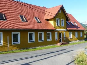 a large yellow house with an orange roof at STANICA in Nowy Gierałtów