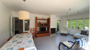 a bedroom with a bed and a living room at Villa Pals Carles Piscina in Pals