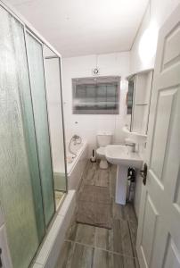 a bathroom with a sink and a shower and a toilet at Eden Wilds Unit 48 & 47 & 31 in Port Edward