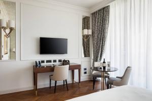 a hotel room with a desk and a television at Palazzo di Varignana in Varignana